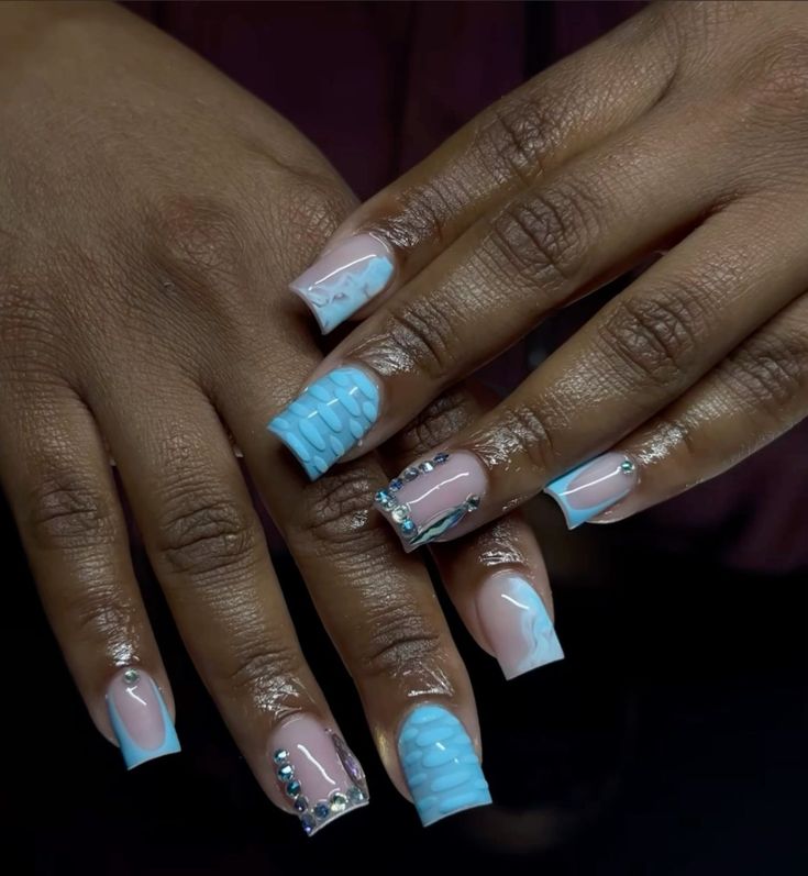 Elegant Colorful Nail Design: Soft Pink and Light Blue with Intricate Patterns and Shiny Embellishments.