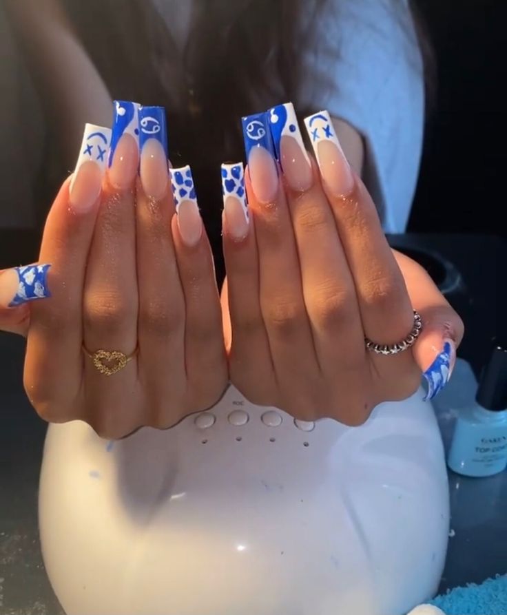 Trendy Eye-Catching Long Square Nail Design with Blue Accents and Playful Patterns.