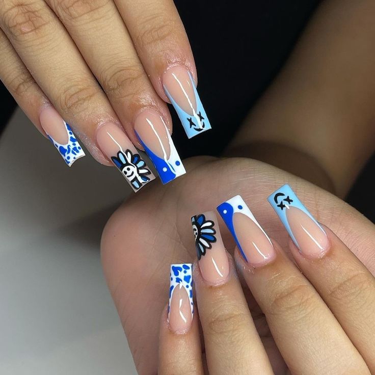 Eye-Catching Vibrant Blue and White Floral Nail Design on Long Almond Nails.