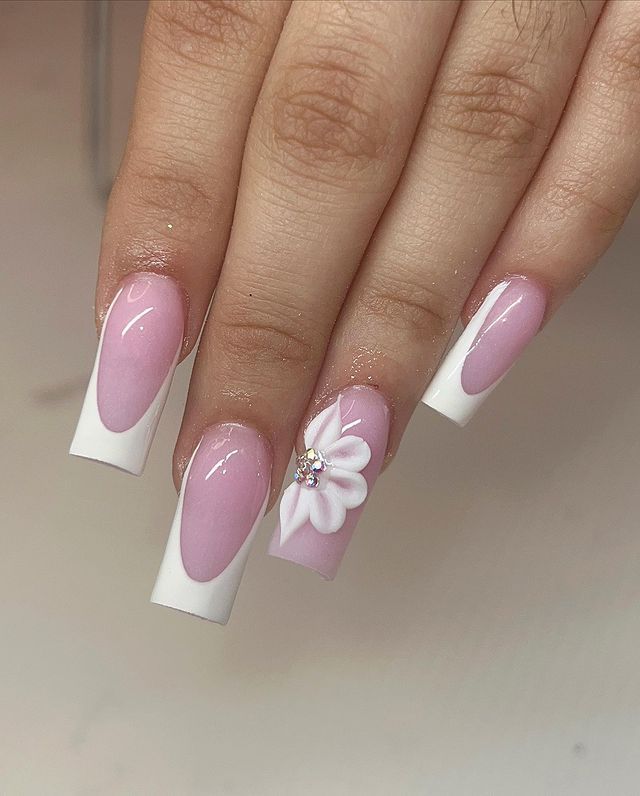 Chic Pink and White Nail Design with Floral Accent and Rhinestone.