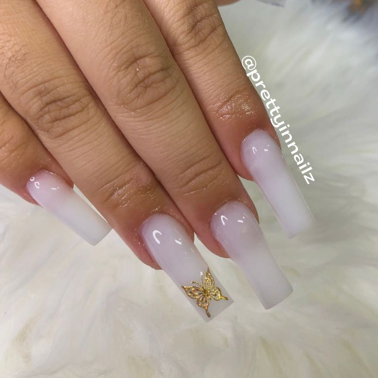 Elegant Ombre Nail Design with Gold Butterfly Charm for a Stylish Aesthetic.