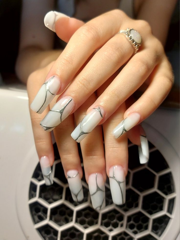 Sophisticated Long Coffin Nails: Soft White and Light Gray Marble Design with Delicate Black Accents.