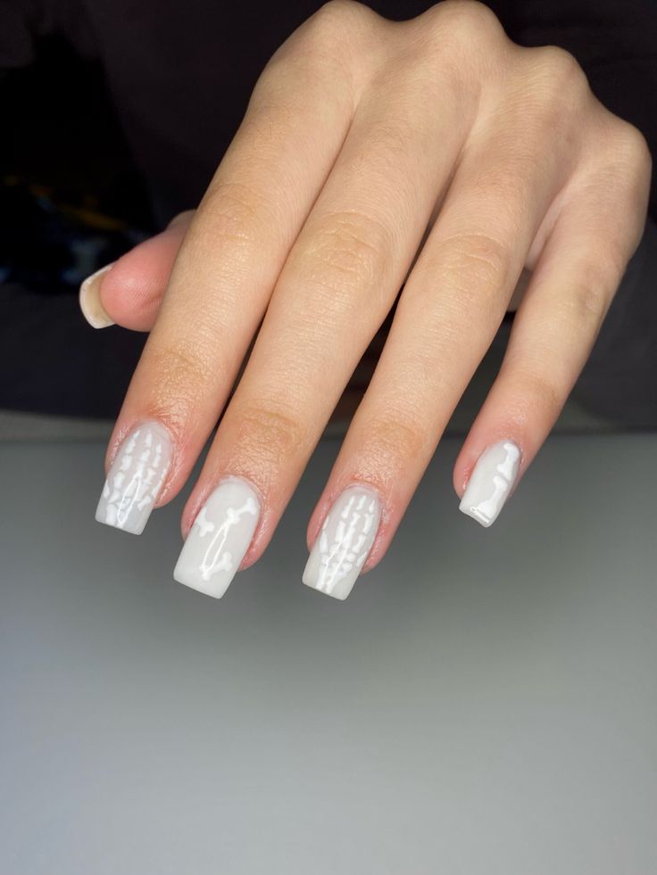 Chic Elegant White Nail Design with Glossy Finish and Intricate Matte-Gloss Patterns.