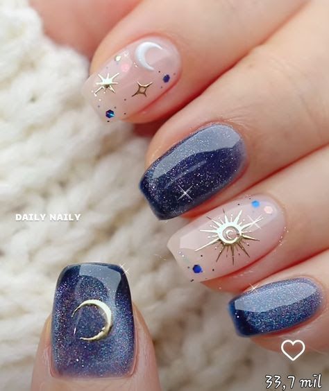 Celestial Nail Art: Deep Navy and Nude Design with Whimsical Metallic Accents and Shimmering Glitter