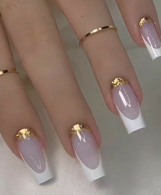 Elegant Pink and White Gradient Nail Design with Luxurious Gold Leaf Accents.