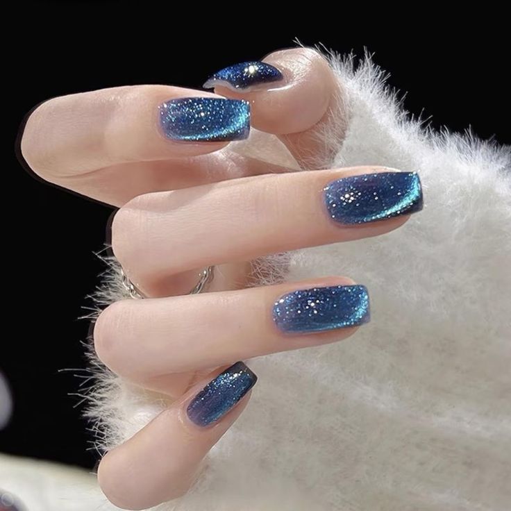 Mesmerizing Sparkling Blue Ombre Nails: A Glamorous Gradient Design.