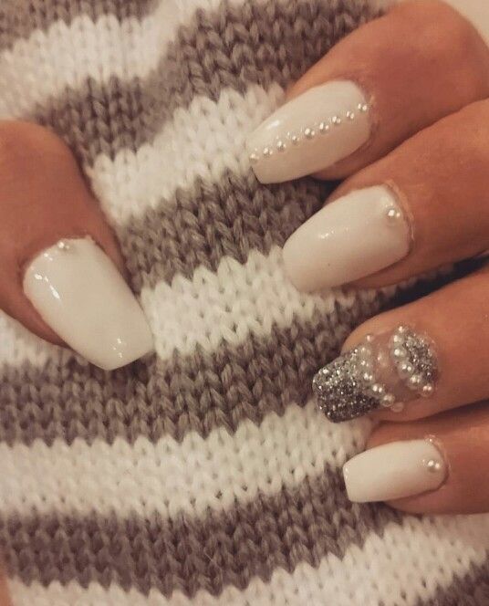 Chic Elegant Nail Design: Soft White Base with Silver Glitter and Beaded Accents.