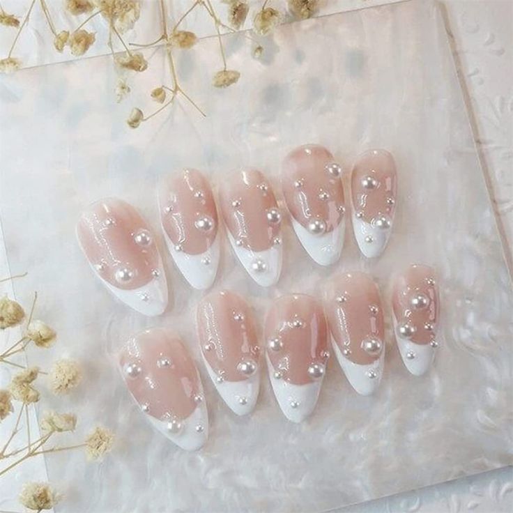 Sophisticated Chic: Elegant Nude Nails with Glossy White Tips and Pearl Embellishments