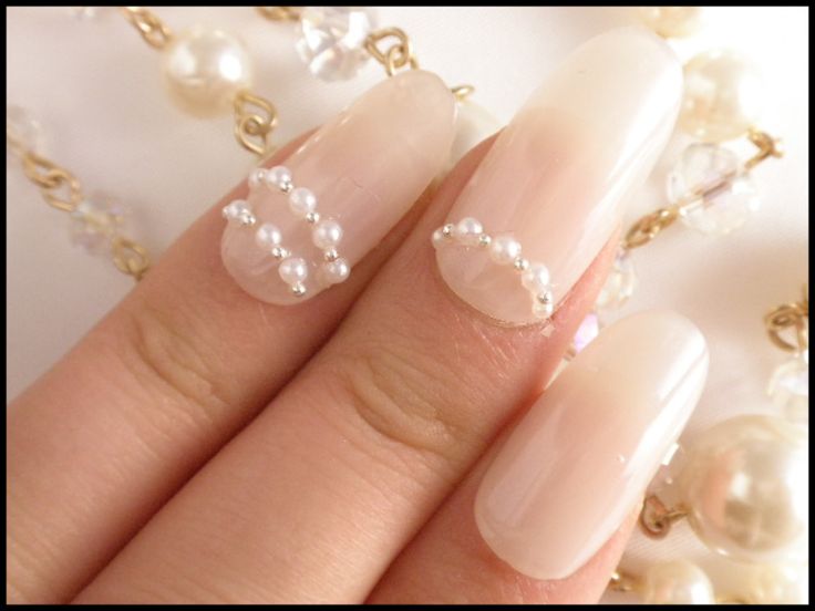 Sophisticated Nude Nails with Delicate Pearl Accents for Understated Glamour.