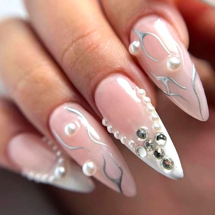 Sophisticated Soft Pink Nail Design with Fluid Silver Lines and Pearl-Rhinestone Accents.