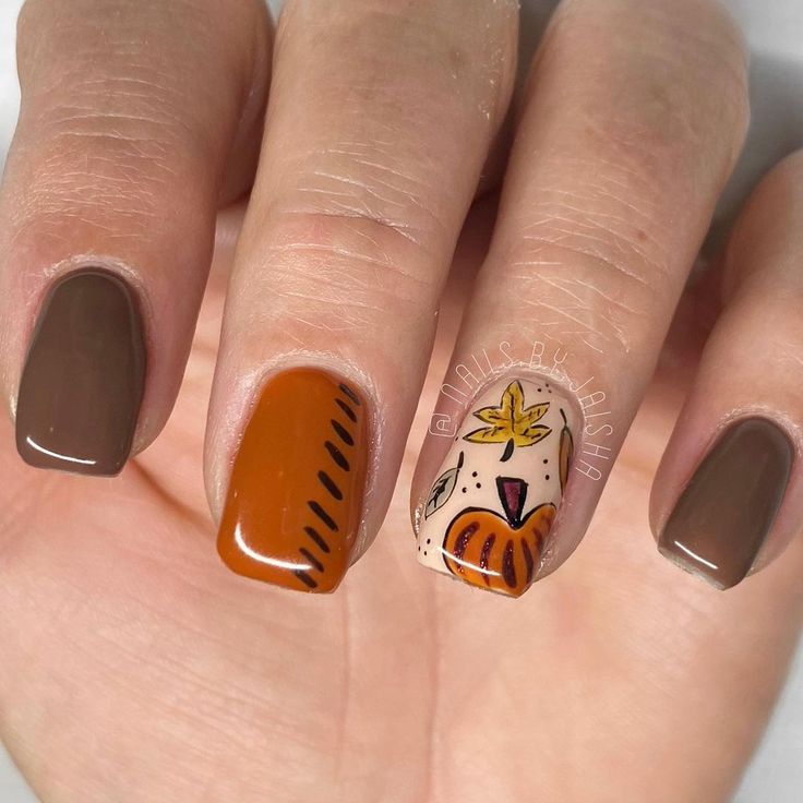 Whimsical Autumn-Inspired Nail Design in Warm Browns and Vibrant Oranges with Pumpkin and Leaf Accents.