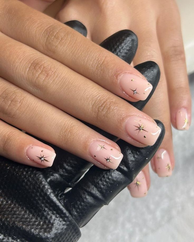 Chic Celestial Nail Design with Nude Base and Whimsical Star Motifs