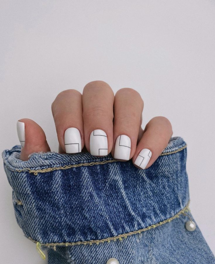 Chic Geometric Nail Design: Modern Minimalism with Bold Black Lines on White Base.