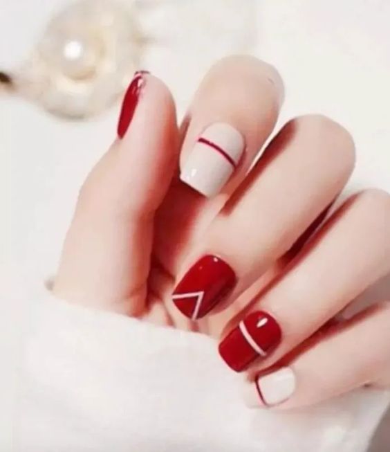 Elegant Chic Red and Neutral Geometric Nail Design.