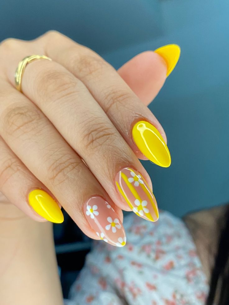 Cheerful Floral Nail Design with Bright Yellow Accents and Pointed Tips.