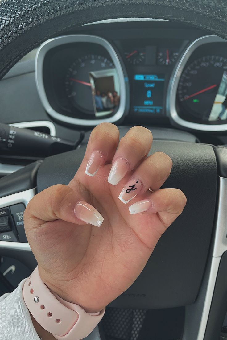 Elegant French Tip Nails: A Modern Blend of Nude and White with Unique Nail Art.