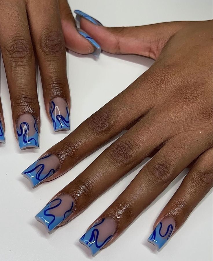 Stunning Gradient Blue Wave Pattern Nail Design with Elongated Square Tips.