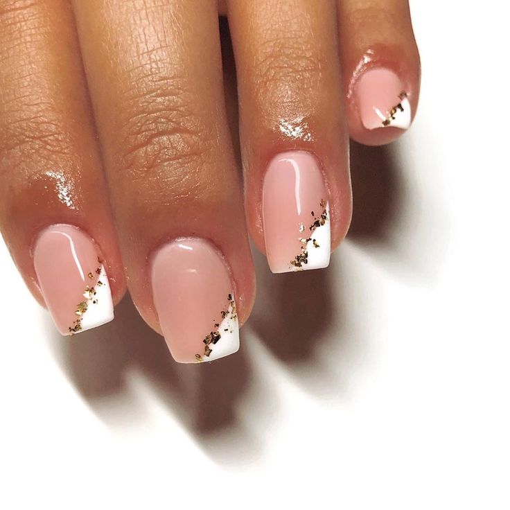 Chic Nail Design: Soft Pink and White with Glamorous Gold French Tips.