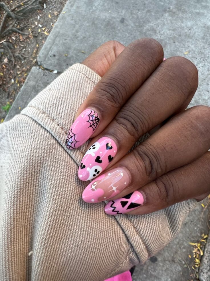 Whimsical Pink Nail Design with Cute Motifs and Unique Flair