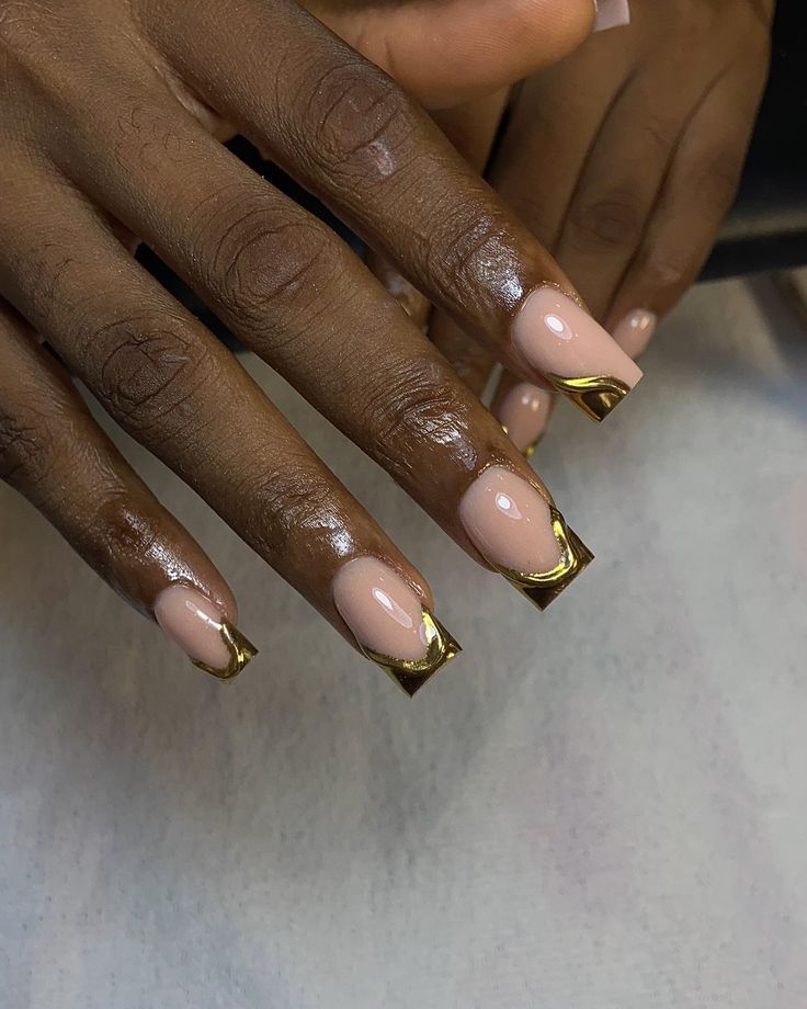 Elegant Nude Nail Design with Luxurious Gold Accents