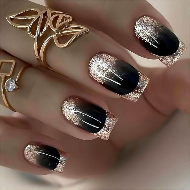 Elegant Gradient Manicure: Glossy Black Meets Shimmering Rose Gold with Glittery Tips and Delicate Gold Accents.