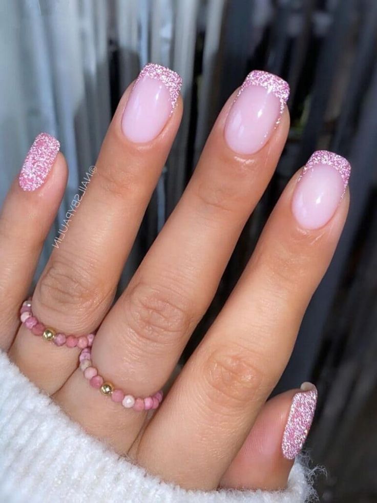 Chic Soft Pink Nail Design with Glitter Tips for Elegant Occasions.