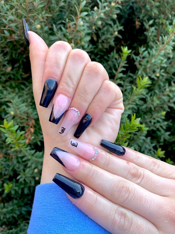 Chic Nail Design: Glossy Black and Soft Nude with Geometric Patterns and Rhinestones.