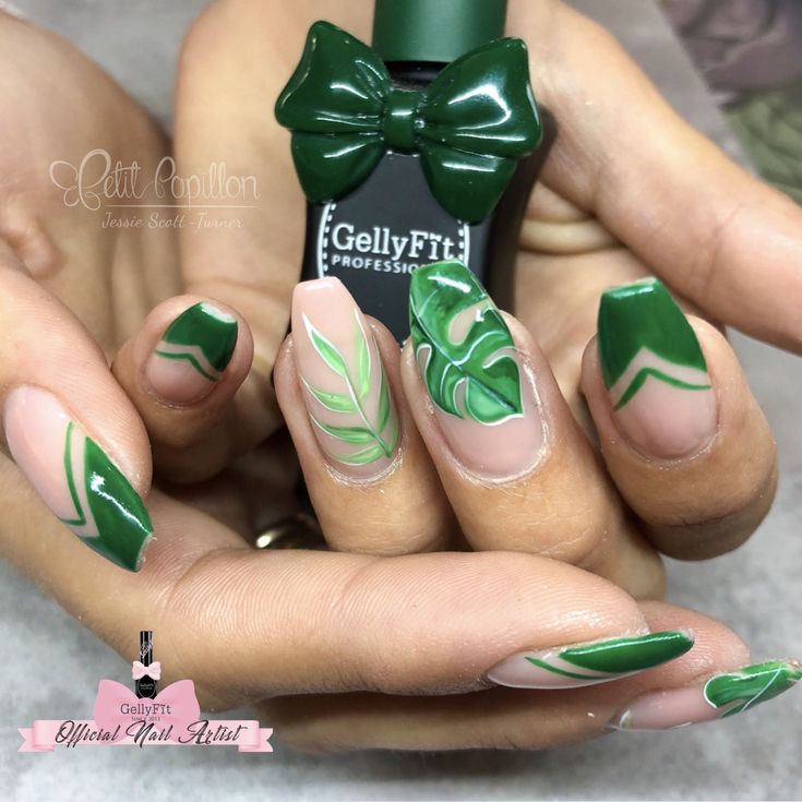 Playful Elegant Nail Design: Vibrant Green with Leaf Patterns and Bow Embellishment.