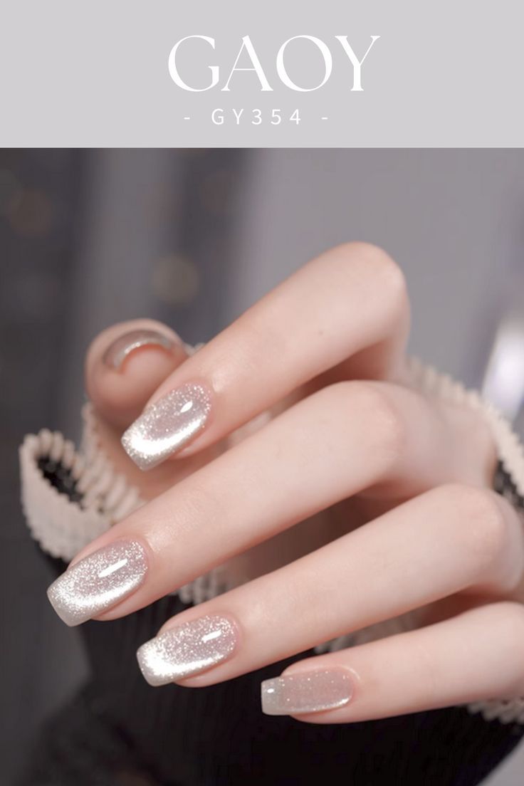 Sophisticated Nail Design: Gradient Nude with Sparkling Silver Tips.