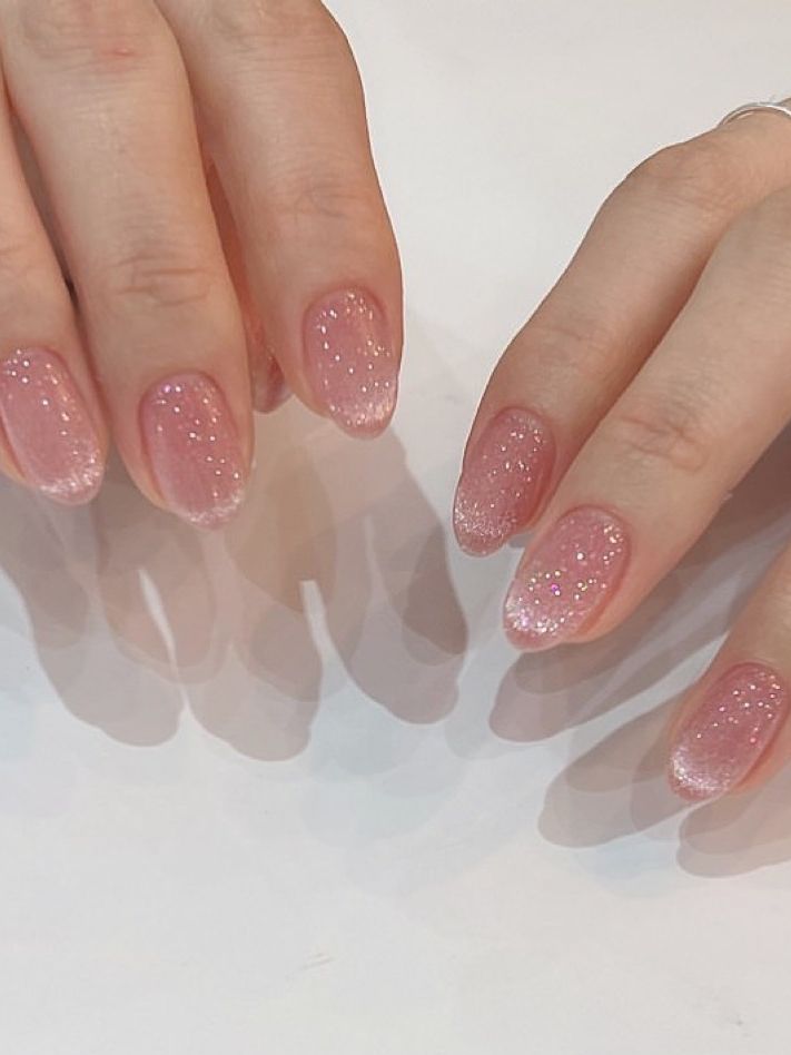 Delicate Pink Ombre Manicure with Subtle Glitter for Elegant Everyday Glamour.