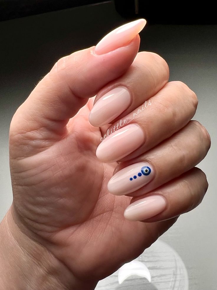 Chic Nude Nail Art with Striking Blue and White Accent Design.