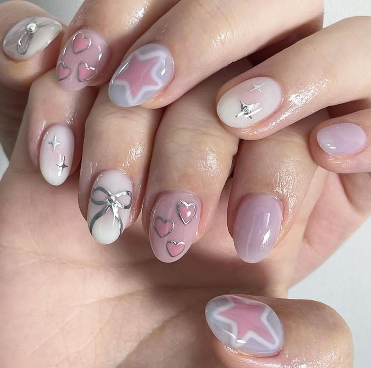 Charming Pastel Nail Design with Whimsical Patterns and Glossy Finish.