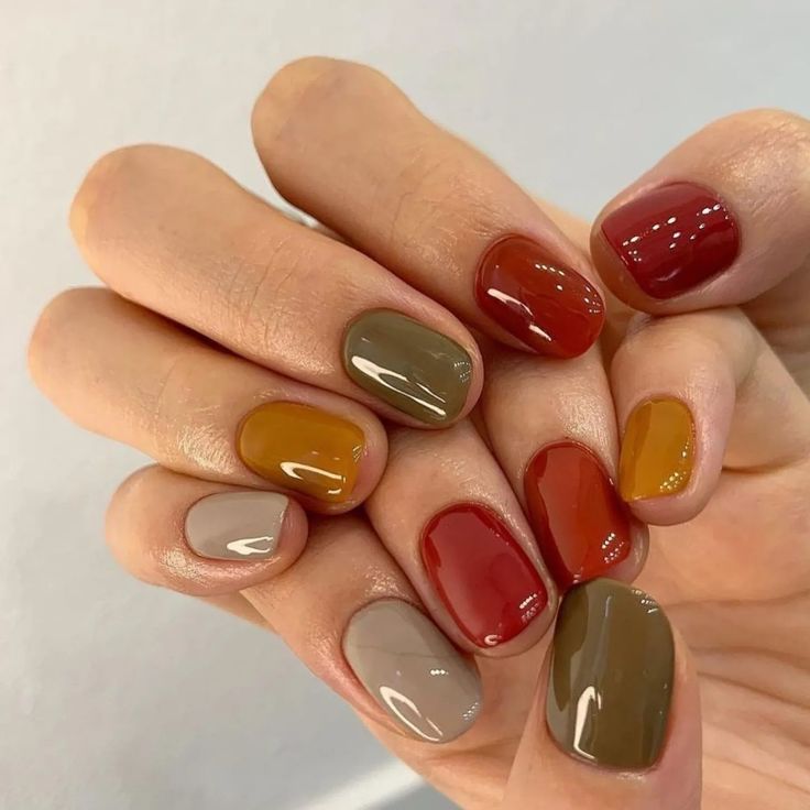 Vibrant Autumn-Inspired Nail Design with Rich Shades and Glossy Finish.