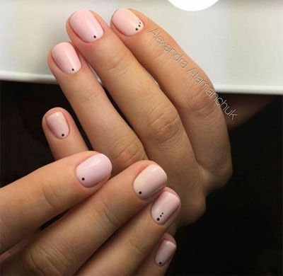 Sophisticated Minimalist Nail Design: Soft Pink Base with Elegant Black Dot Accents.