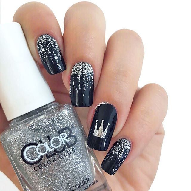 Sophisticated Black and Silver Glitter Nail Design with Regal Crown Accent.