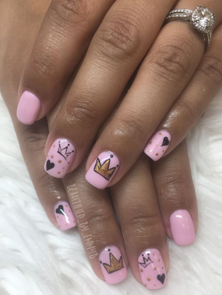 Charming Whimsical Nail Art: Soft Pink Base with Sparkling Crowns and Polka Dots