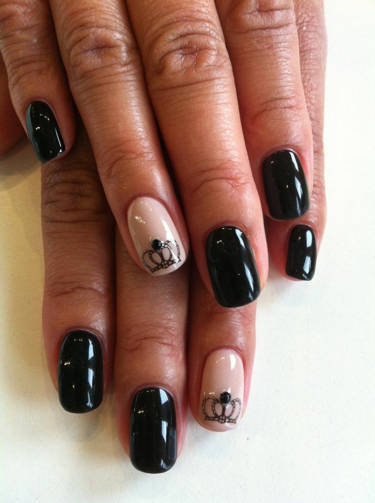 Sophisticated Elegant Nail Design: Glossy Black and Soft Nude with Regal Crown Accents.