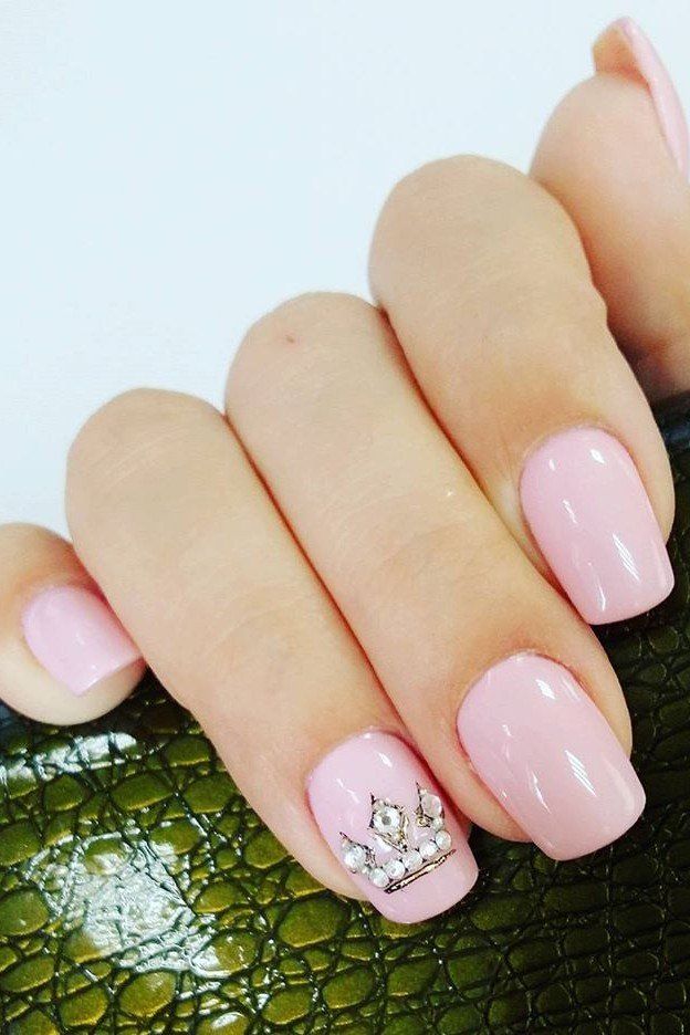 Elegant Pink Nail Design with Glossy Finish and Crown Accent