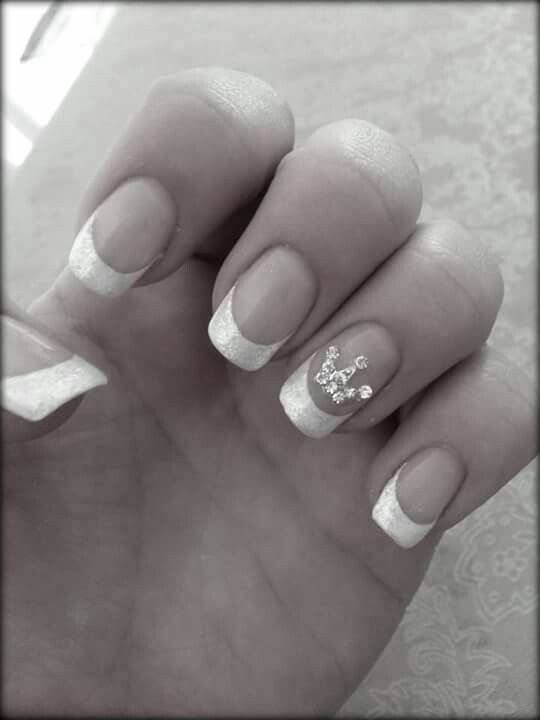 Elegant Shimmering French Manicure with Rhinestone Accents.