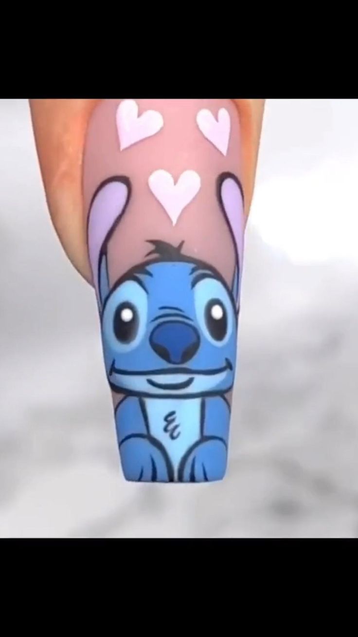 Charming Whimsical Nail Design with Playful Blue Character and Pastel Hearts