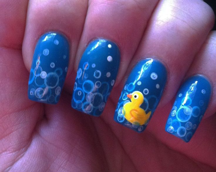 Whimsical Blue Nail Design with Bubble Art and Rubber Duck Accent.