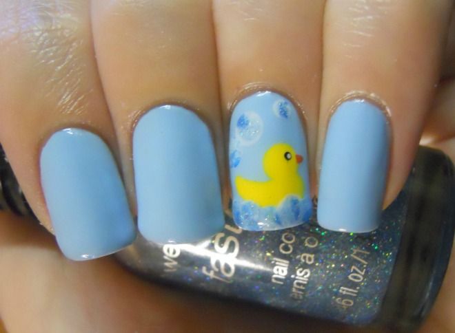 Whimsical Blue Nail Design with Playful Yellow Duck Accent