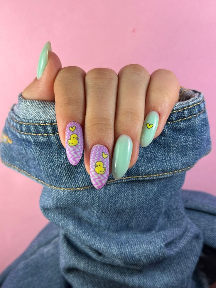 Playful Pastel Nail Design with Zigzag Patterns and Cheerful Duck Motifs.