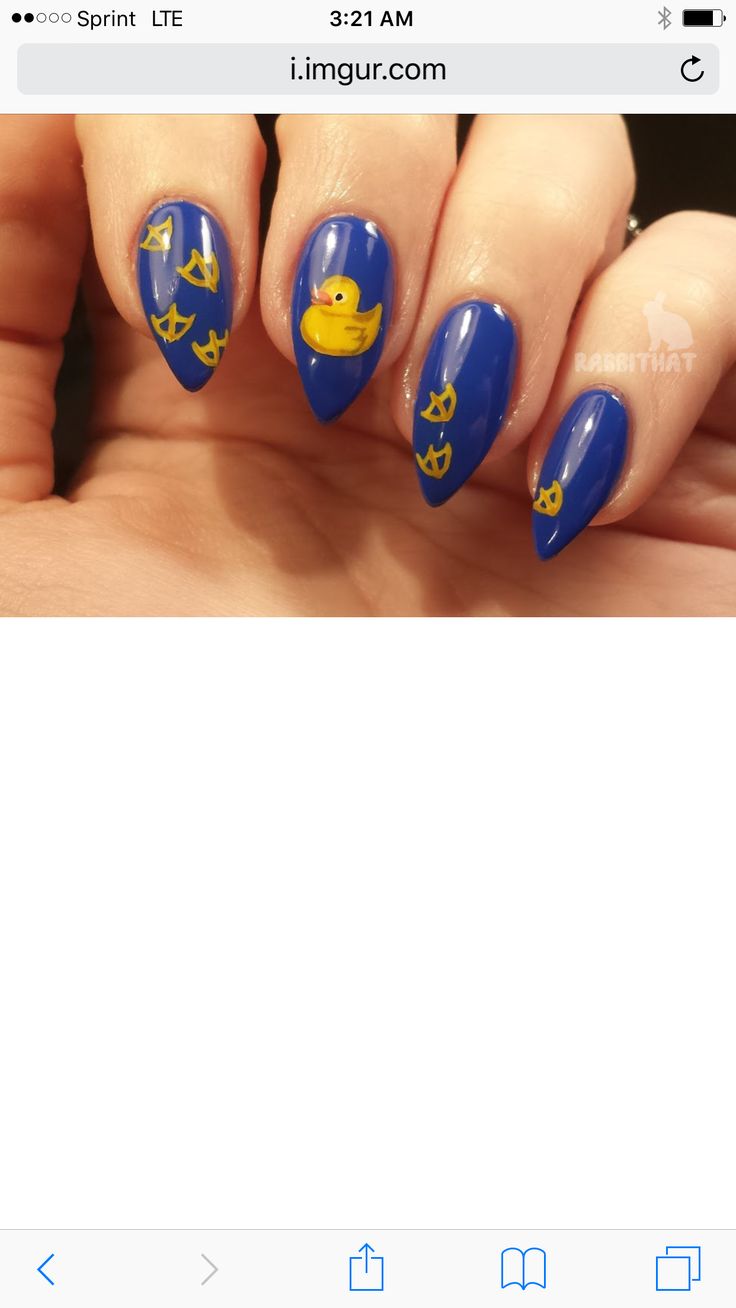 Playful Blue Nail Design with Yellow Accents and Whimsical Motifs.