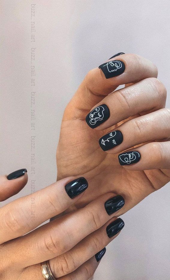 Chic Black Nail Design with Unique Minimalist Line Art Accents.