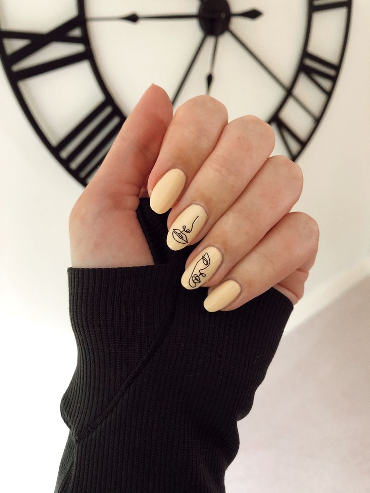 Chic Minimalist Nail Art: Soft Beige Base with Sophisticated Black Line Illustrations.