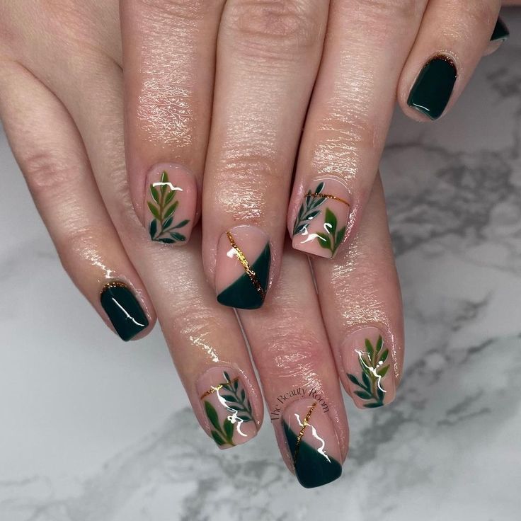 Sophisticated Botanical Nail Design with Dark Green and Nude Polish Accented by Gold Detailing.