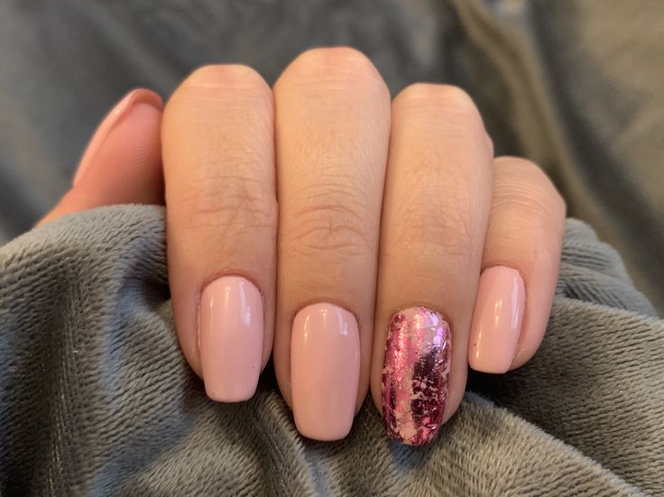 Chic Soft Pink Nail Design with Glamorous Metallic Accent.