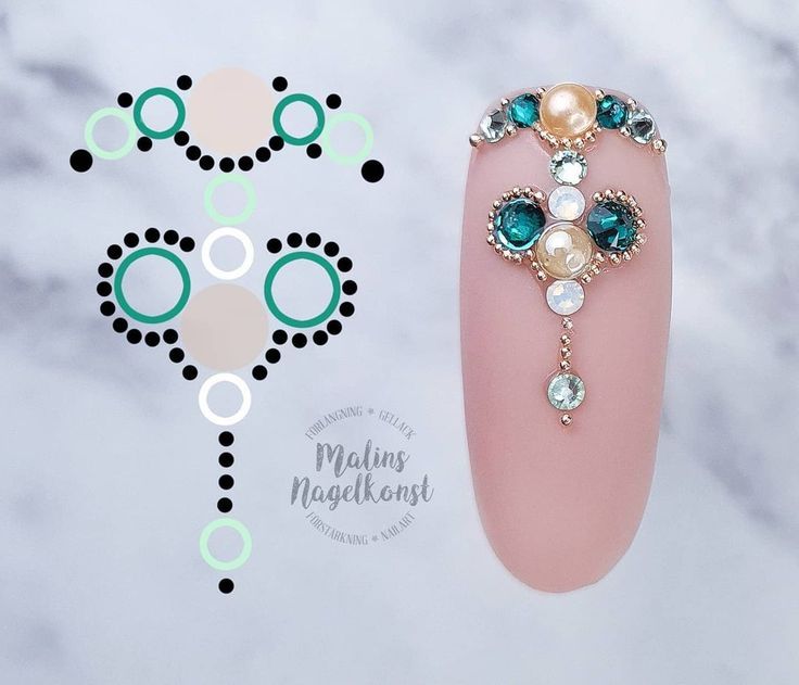 Sophisticated Nail Art: Intricate Gemstone Embellishments on a Soft Pink Base.