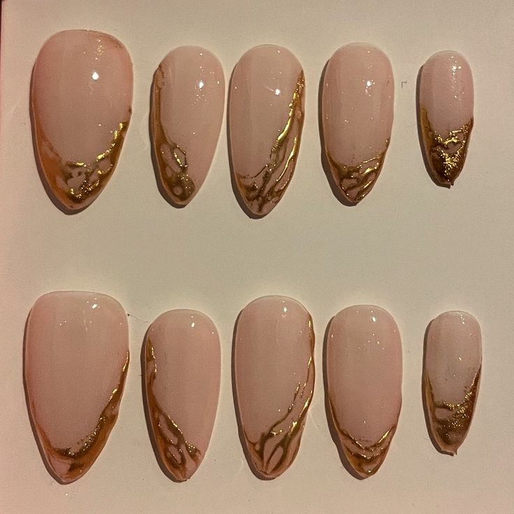 Chic Nude Nail Design with Elegant Gold Accents for Versatile Sophistication.